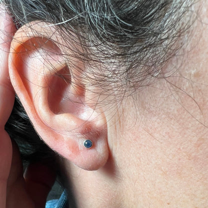 Woman wearing September Birthstone earrings