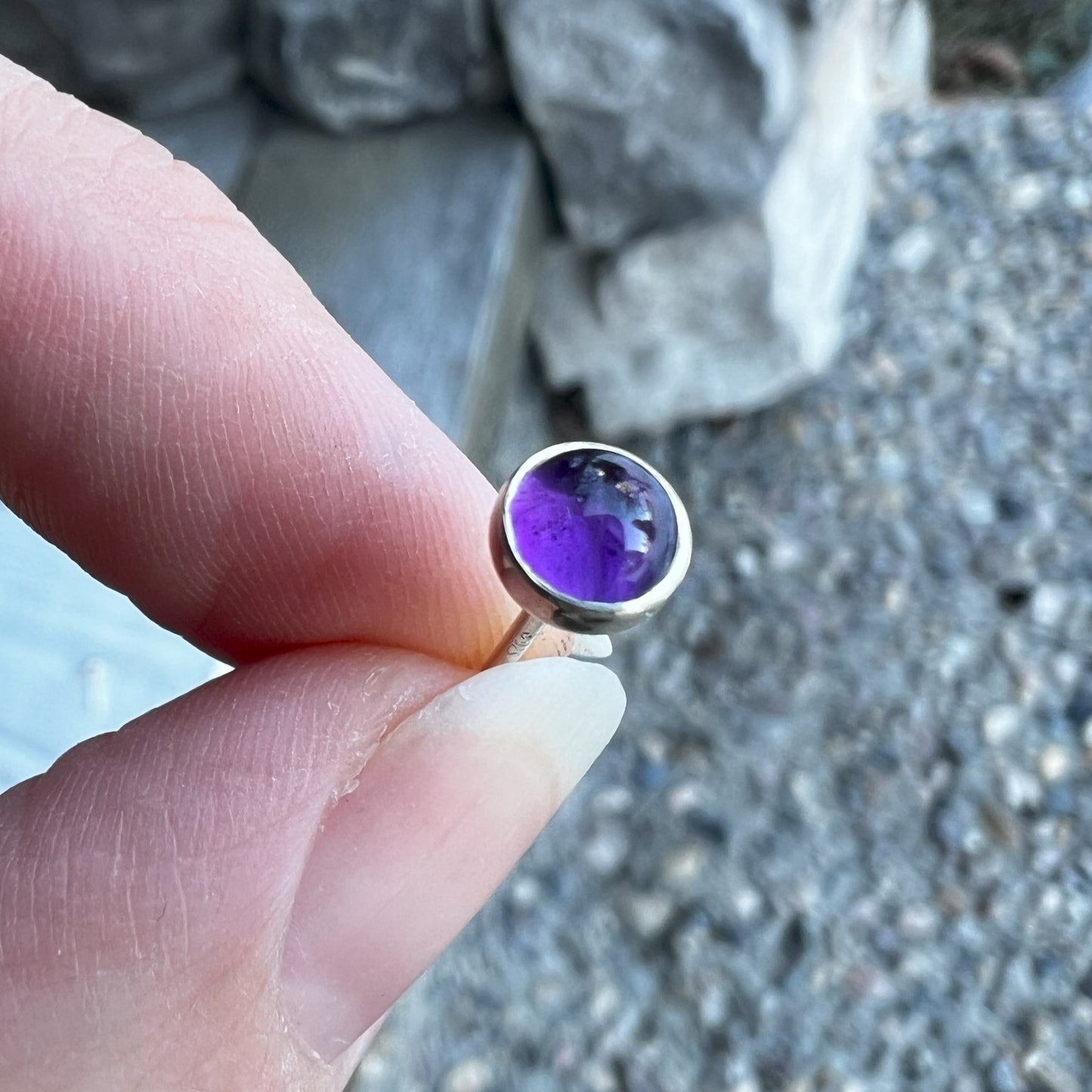 Holding an Amethyst Birthstone Earring 