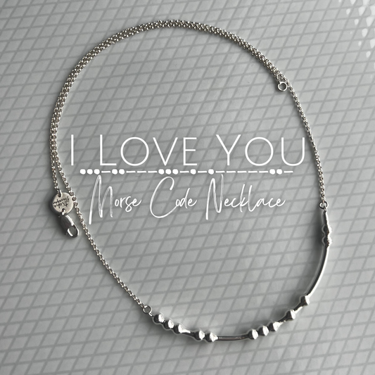 I Love You Morse Code Necklace laying on a plate