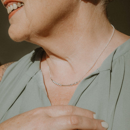 Woman wearing a Morse Code Necklace