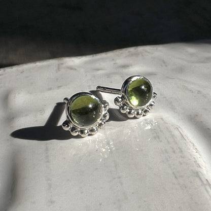 Peridot Eyelash Stud Earrings in the sunlight