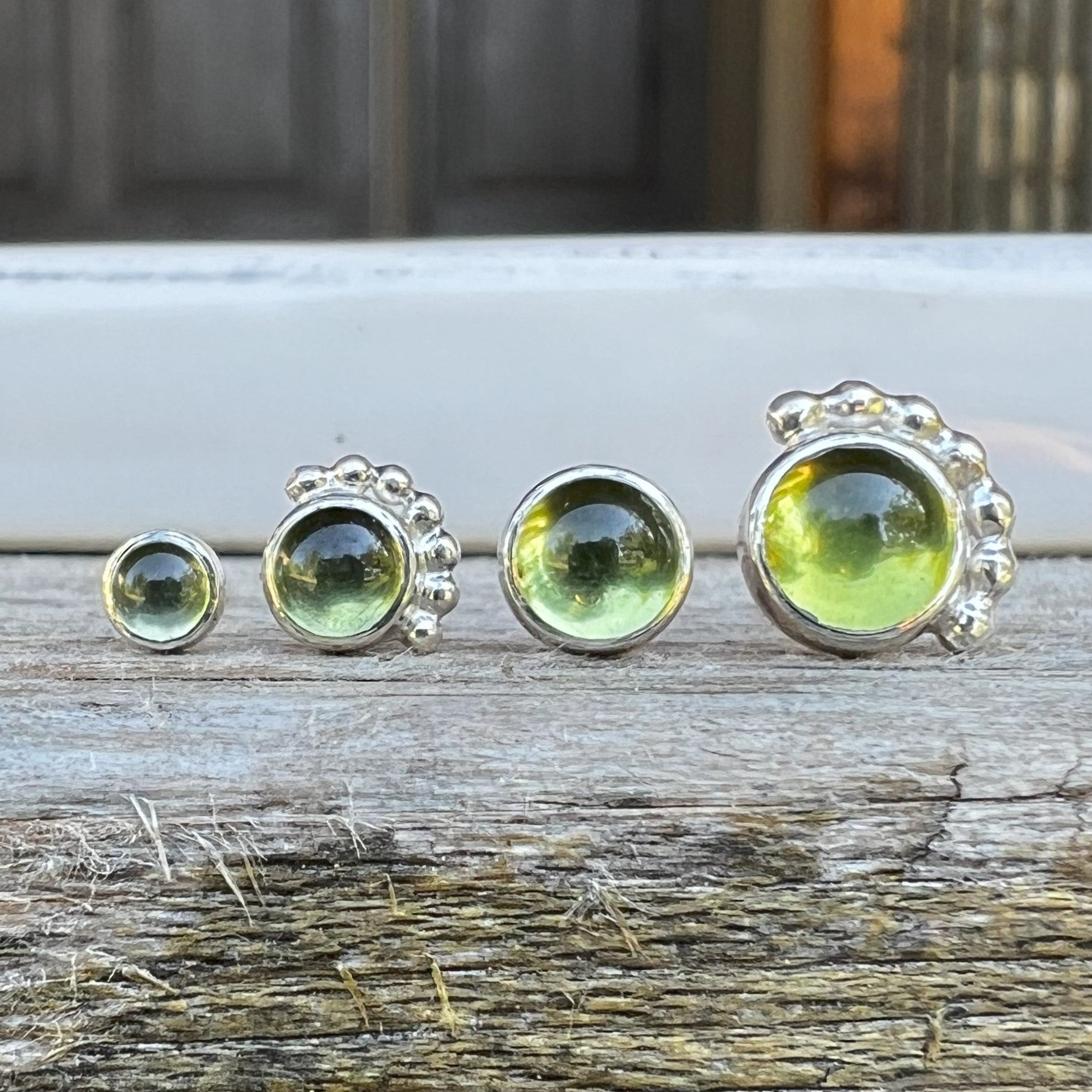 Women's Peridot Stud Earrings in a row with other peridot stud earrings