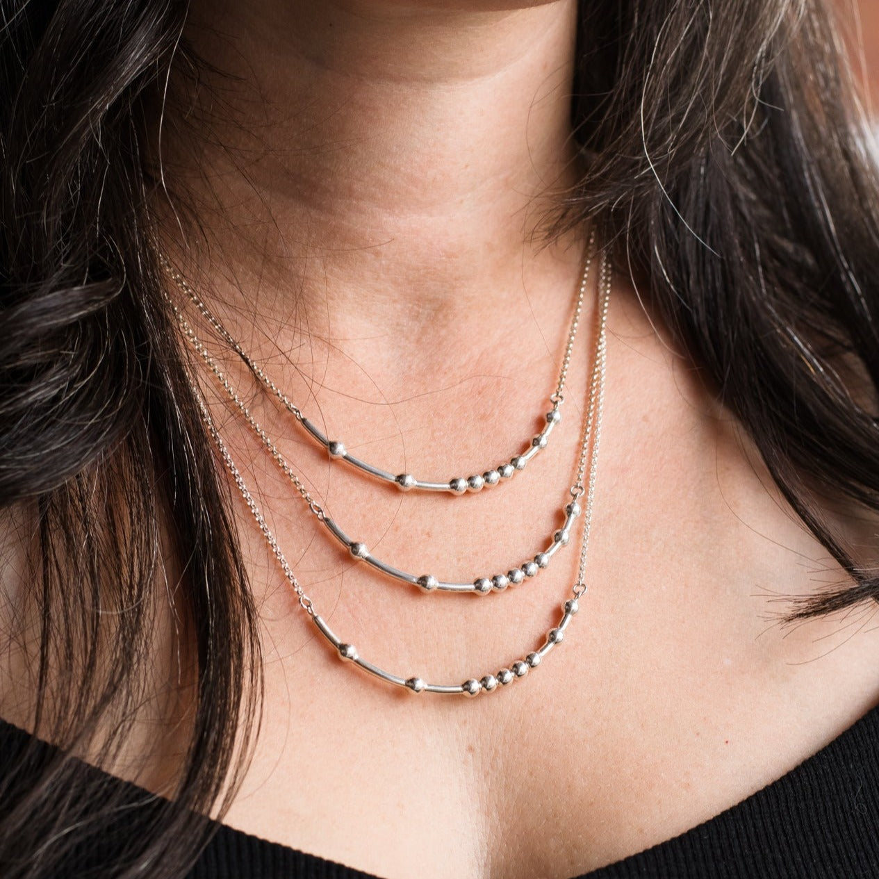 Woman wearing three sizes of chain - Trisha Flanagan